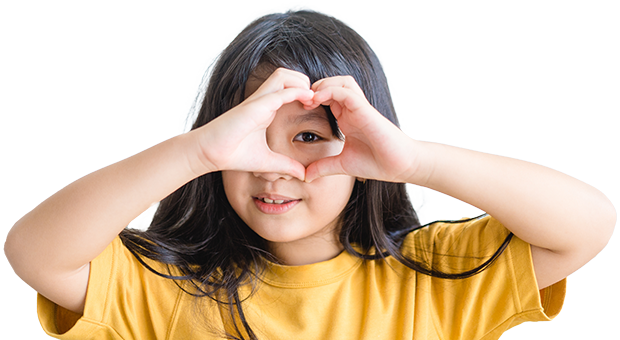 Girl making a heart over her eye with her hands